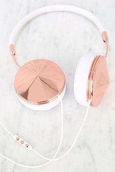 a pair of headphones sitting on top of a white counter next to a phone