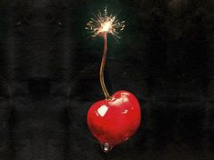 a red apple with a sparkler on it