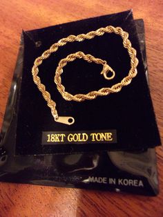 "Classic design rope bracelet is made with an 18kt gold tone finish and measures 7\" in length x 1/8\" wide. Lobster claw clasp which holds securely. Bracelet has original packaging and was made in Korea. Excellent condition and does not appear to have ever been worn." Vintage Gold-tone Chain Bracelets, Vintage Gold-tone Gold-plated Bracelet, Vintage Hallmarked Link Gold Bracelet, Vintage Yellow Gold Tarnish-resistant Bracelet, Bracelet Rope, Luxury Vintage Gold-tone Chain Bracelet, Long Bracelet, Rhinestone Jewelry Set, Vintage Madame Alexander Dolls