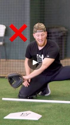 a man kneeling on top of a field holding a baseball glove