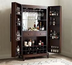 a cabinet with wine glasses and liquor bottles in it