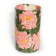 a pink flowered vase sitting on top of a white table