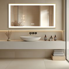 a bathroom with a sink, mirror and towels on the counter top in front of it