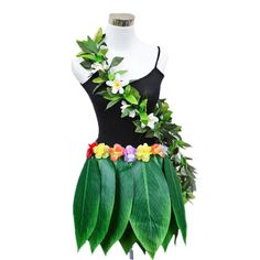 a dress made out of leaves and flowers on a mannequin's head