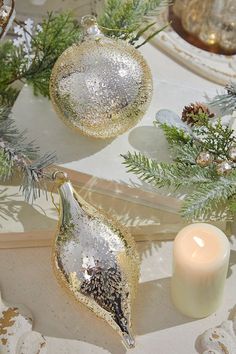 christmas ornaments and candles on a table