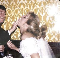 a bride and groom are feeding each other cake at their wedding reception in an old photo