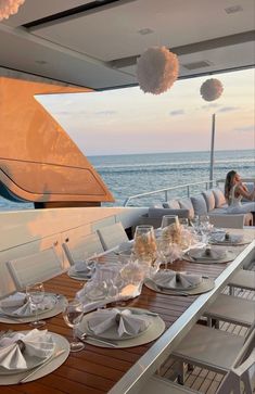 the dining table is set with plates and silverware on it, overlooking the ocean