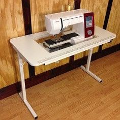 a sewing machine sitting on top of a white table