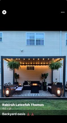 an image of a patio with lights on the roof and furniture in the back yard