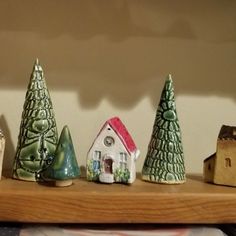 small ceramic houses and trees on a shelf