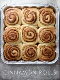 cinnamon rolls in a baking pan with the words cinnamon rolls written on top and bottom