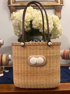 Handwoven Nantucket Lightship Basket Tote bag made by Abby Fisher. Tote features maple staves, rim and base with 18” leather straps, and bone scallop shell carving. Each piece has a logo button on the bottom of the bag with scrimshaw noting the year the bag was made and signature of artist, Abby Fisher. Bag dimensions are 8” tall, 8.5” long across the top, and 4” wide. This heirloom piece will last a lifetime and as in the traditional Nantucket custom,can be past down to future generations. Plea Lightship Basket, Nantucket Basket, Shell Carving, Basket Case, Scallop Shell, Scallop Shells