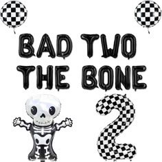 the number two balloon is decorated with a skeleton and checkerboard pattern, as well as balloons that read'bad two the bone 2 '