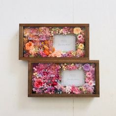 two wooden frames with flowers on them