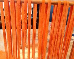 an orange chair with wooden slats on it