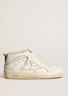 Kick your sneaker game up a notch with the Golden Goose Deluxe Brand Mid Star Shearling Sneakers. These playful kicks feature a shearling lining and padded collar for ultimate comfort, while the signature distressed upper adds a unique, lived-in look. With wingtip brogue details and a star and perforation design, these sneakers are sure to make a statement. Available in White/Beige Upper: 86% Goat Leather, 14% Cow Leather Lining: 88% Ovine Leather, 12% Cow Leather Sole: 100% rubber Handcrafted M High Star Golden Goose, Golden Goose Shearling, Golden Goose Sabot Shearling, Perforation Design, Golden Goose Leopard Mid Star, Golden Goose Sky Star, The Golden Goose, Fall Outerwear, Sneakers Street Style