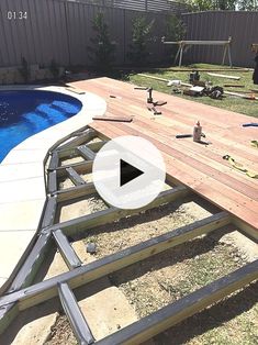 a backyard with a pool being built and some tools laying on the ground next to it