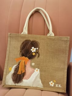 a handbag with a woman's hair and flowers on it sitting on a chair