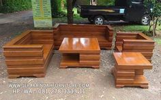 a group of wooden benches sitting on top of a dirt ground next to a tree