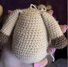 a hand holding a crocheted stuffed animal in it's right hand and two mice on the other side