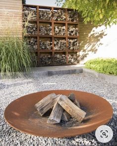 a fire pit in the middle of a gravel area