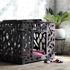 a dog bed in the middle of a room with brick wall and potted plants