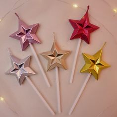 four star shaped lollipop sticks on a plate