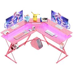 a pink computer desk with two monitors and a keyboard on it, along with other accessories