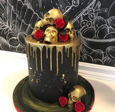 a decorated cake with skulls and roses on top