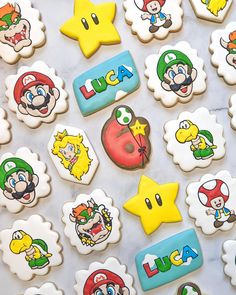 decorated cookies with mario and other characters are on a counter top in front of the camera