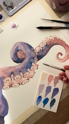 someone is painting an octopus with watercolors