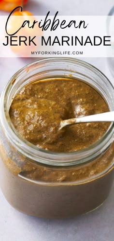 a close up of a jar of food on a table with a spoon in it