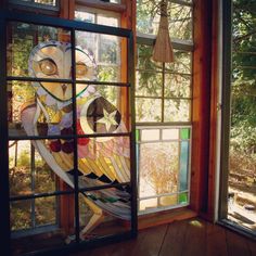 a stained glass owl sitting on top of a window sill