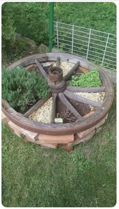 an old wagon wheel is sitting in the grass