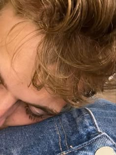 a young boy is hugging his dog on the back of someone's head with their eyes closed