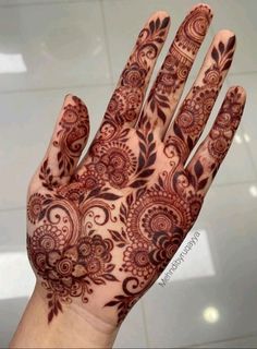 the hand is decorated with intricate designs on it