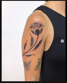 a woman with a flower tattoo on her arm