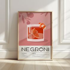 a poster with an orange garnish in a glass on the wall next to a wooden floor