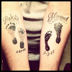 two people with matching tattoos on their arms, one has a baby's foot and the other has an infant's footprints