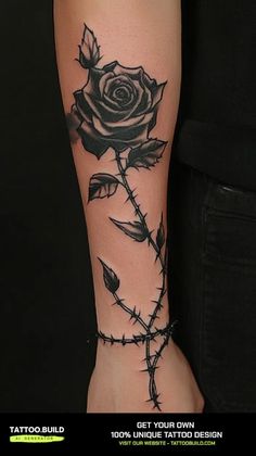 a black rose tattoo on the arm with barbed wire around it and an inscription that reads get your own design