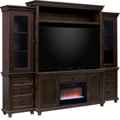 a large entertainment center with a fireplace in it