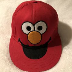 Sesame Street Elmo Embroidered Face Hat Cap Fitted Cap Small / Medium Red. Good used condition. Thanks for looking! Red Hats With Embroidered Logo One Size Fits Most, Red Fun Cap Costume Hats And Headpieces, Fun Embroidered Snapback Hats, Adjustable Flat Bill Red Hat, Red Adjustable Fun Costume Hats And Headpieces, Fun Cap With Embroidered Logo, Fun Red Costume Cap, Red Fitted Hat With Flat Bill, Red Cap Hat, One Size Fits Most