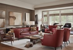 a living room filled with lots of red furniture