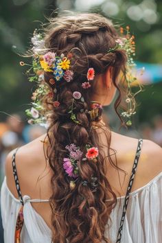 a woman with long hair and flowers in her hair is wearing a flower crown on her head