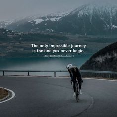 a man riding a bike down a winding road