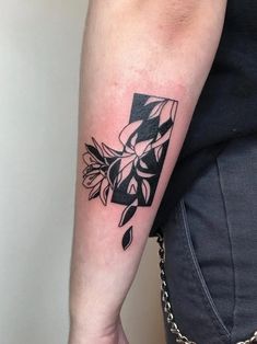 a person with a black and white tattoo on their arm