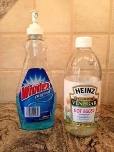 two bottles of vinegar sitting on top of a counter