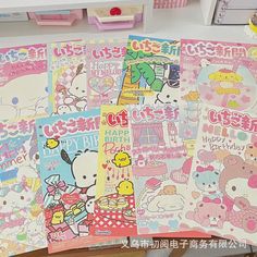 there are many hello kitty posters on the table