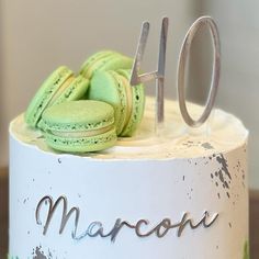 a close up of a cake with macaroons on it and the number forty