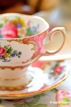 a tea cup and saucer sitting on top of a table